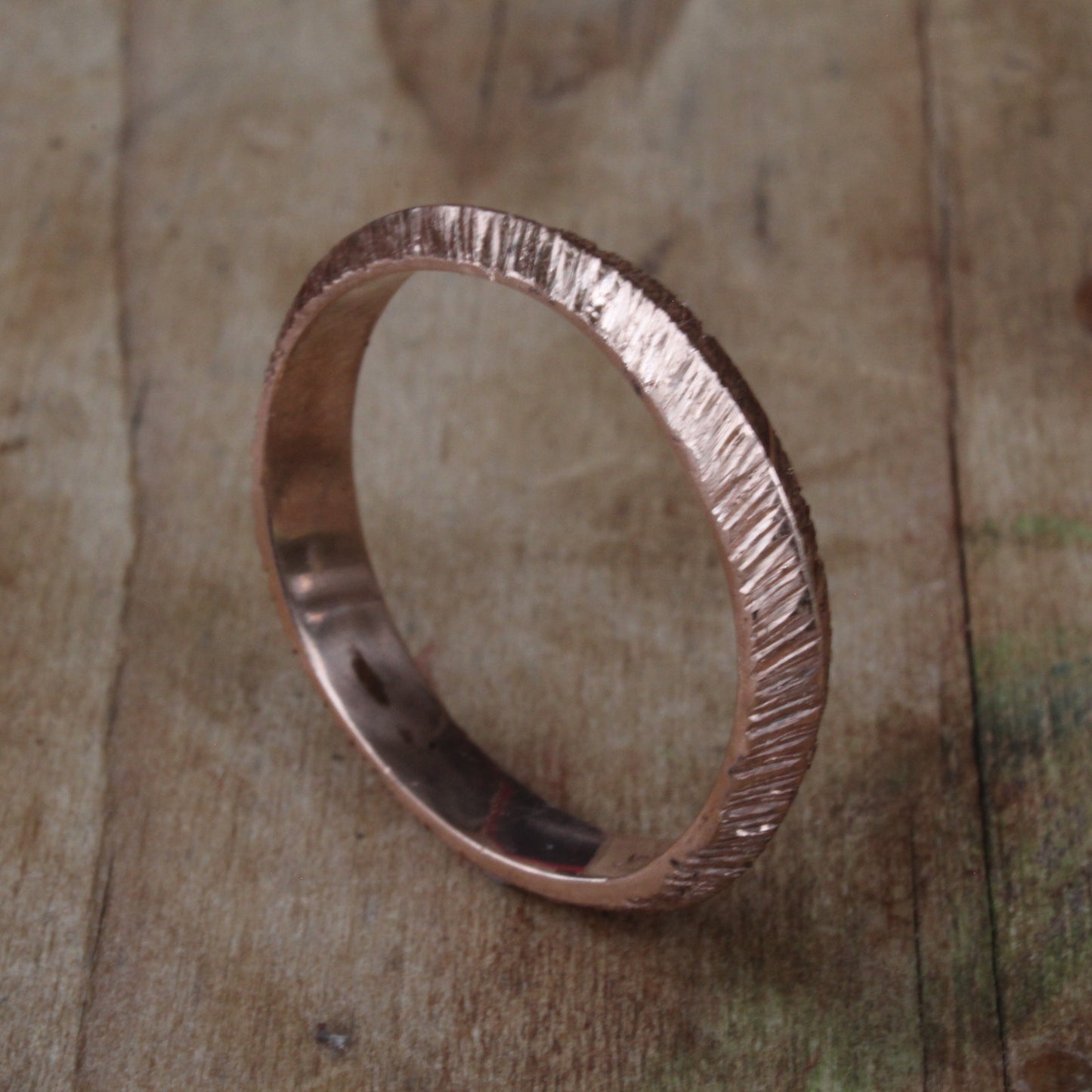 One-of-a-kind unisex ring crafted from 18ct rose/pink gold, featuring a distinctive ripple texture and rounded edges for comfort