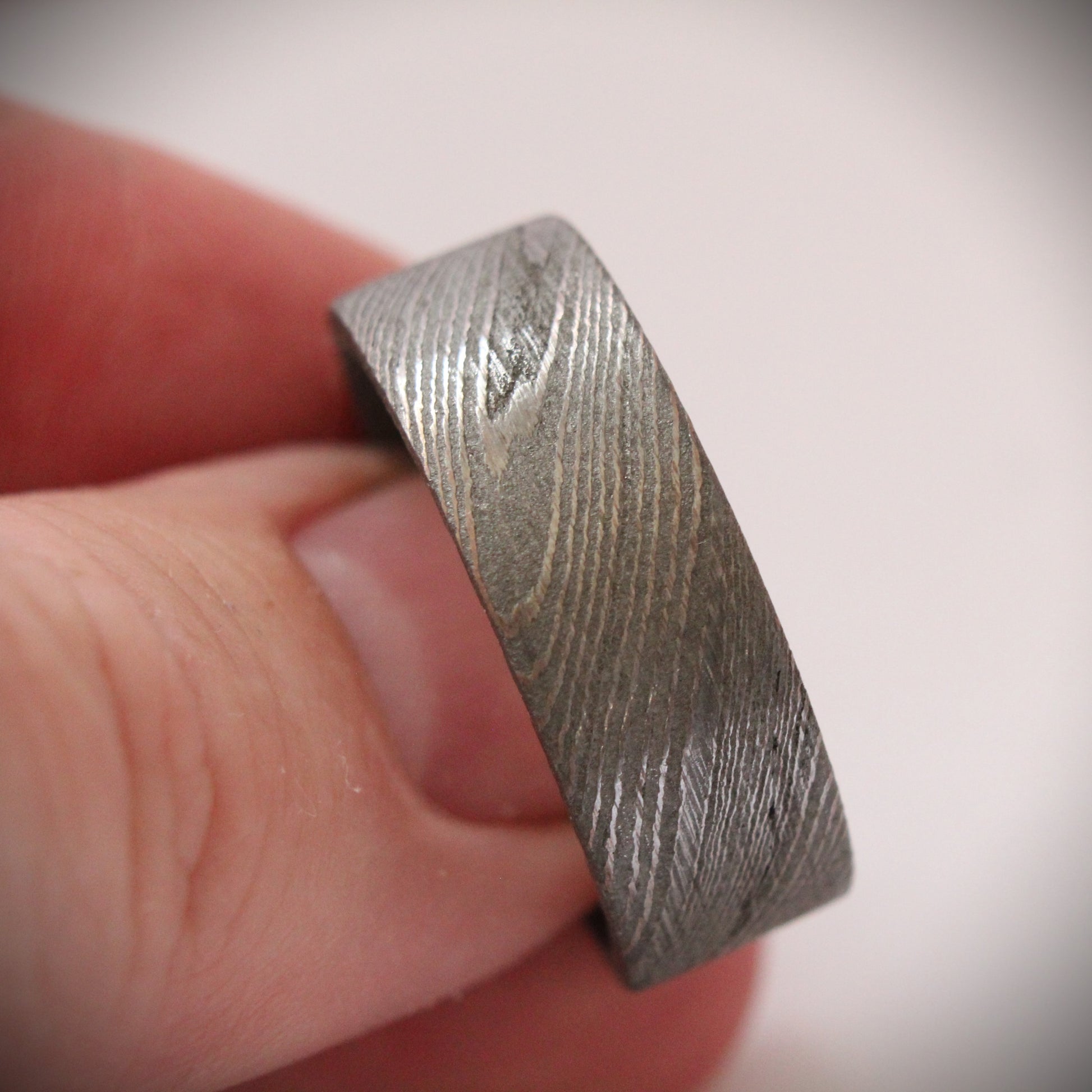 Stunning 9mm Damascus steel ring featuring unique, flowing patterns and exceptional strength. A bold, rugged piece of jewelry that exudes elegance and individuality, perfect as a wedding band, engagement ring, or statement accessory.