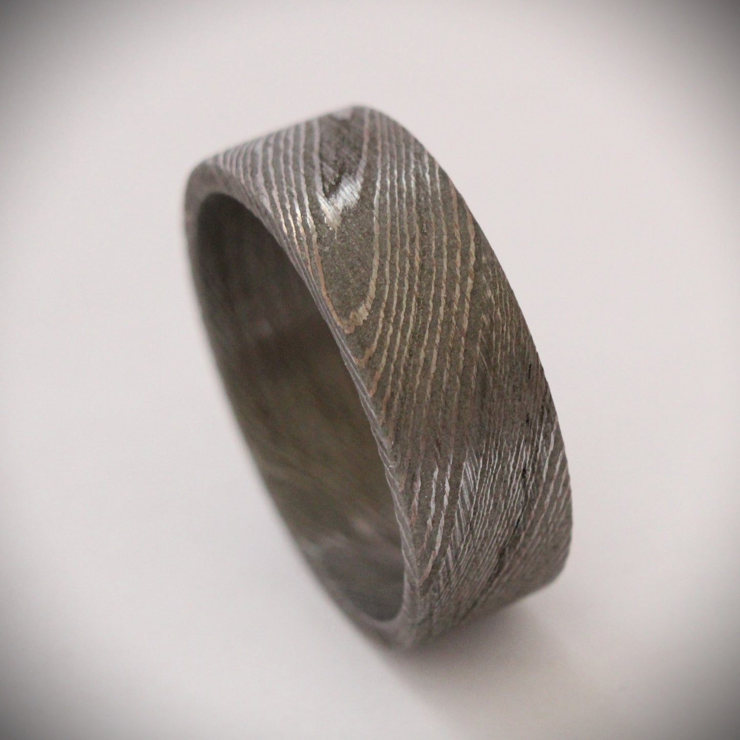 Stunning 9mm Damascus steel ring featuring unique, flowing patterns and exceptional strength. A bold, rugged piece of jewelry that exudes elegance and individuality, perfect as a wedding band, engagement ring, or statement accessory.