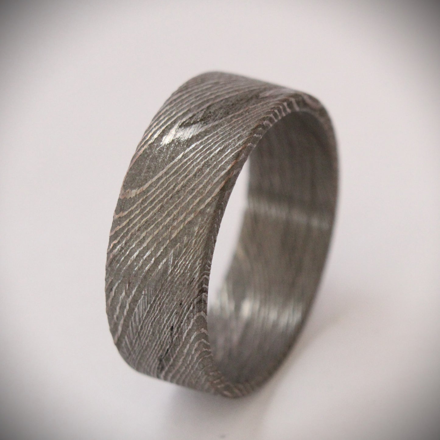 Stunning 9mm Damascus steel ring featuring unique, flowing patterns and exceptional strength. A bold, rugged piece of jewelry that exudes elegance and individuality, perfect as a wedding band, engagement ring, or statement accessory.