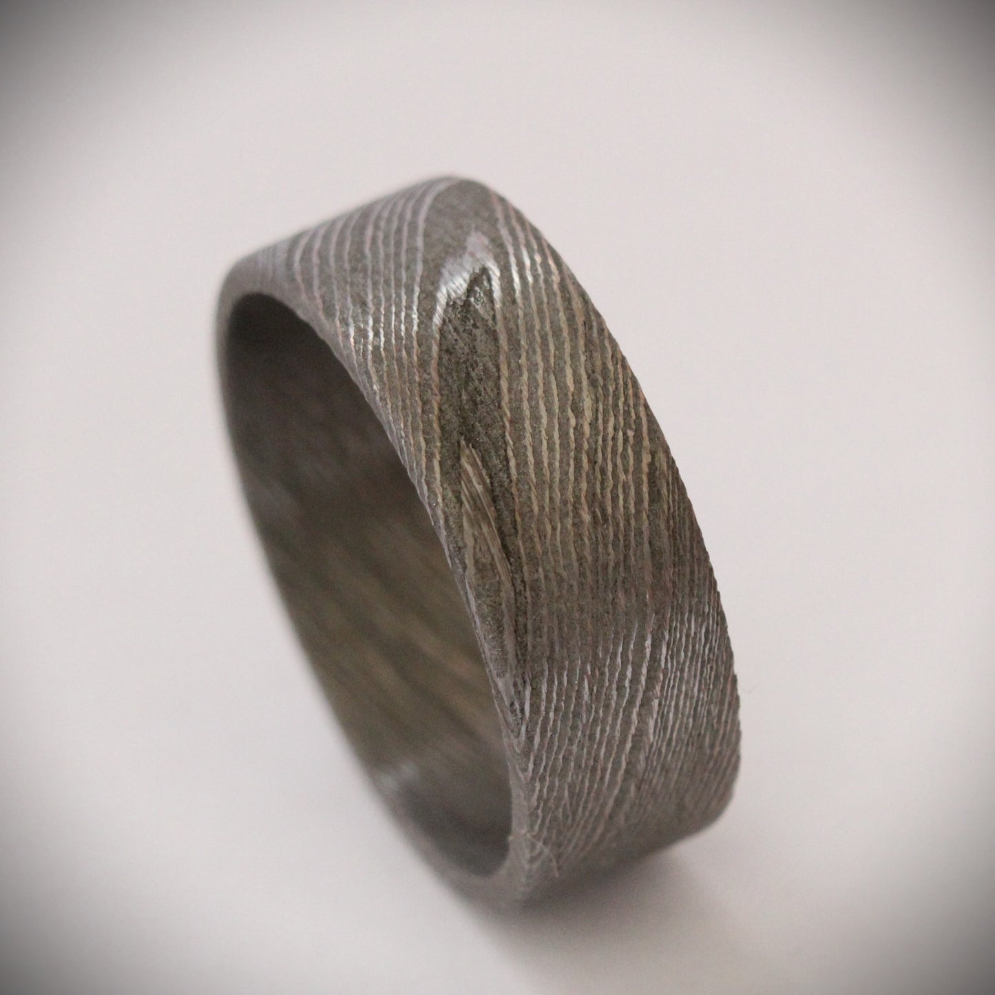 Stunning 9mm Damascus steel ring featuring unique, flowing patterns and exceptional strength. A bold, rugged piece of jewelry that exudes elegance and individuality, perfect as a wedding band, engagement ring, or statement accessory.